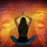 Person meditating with hands in prayer position against an abstract Buddha background.