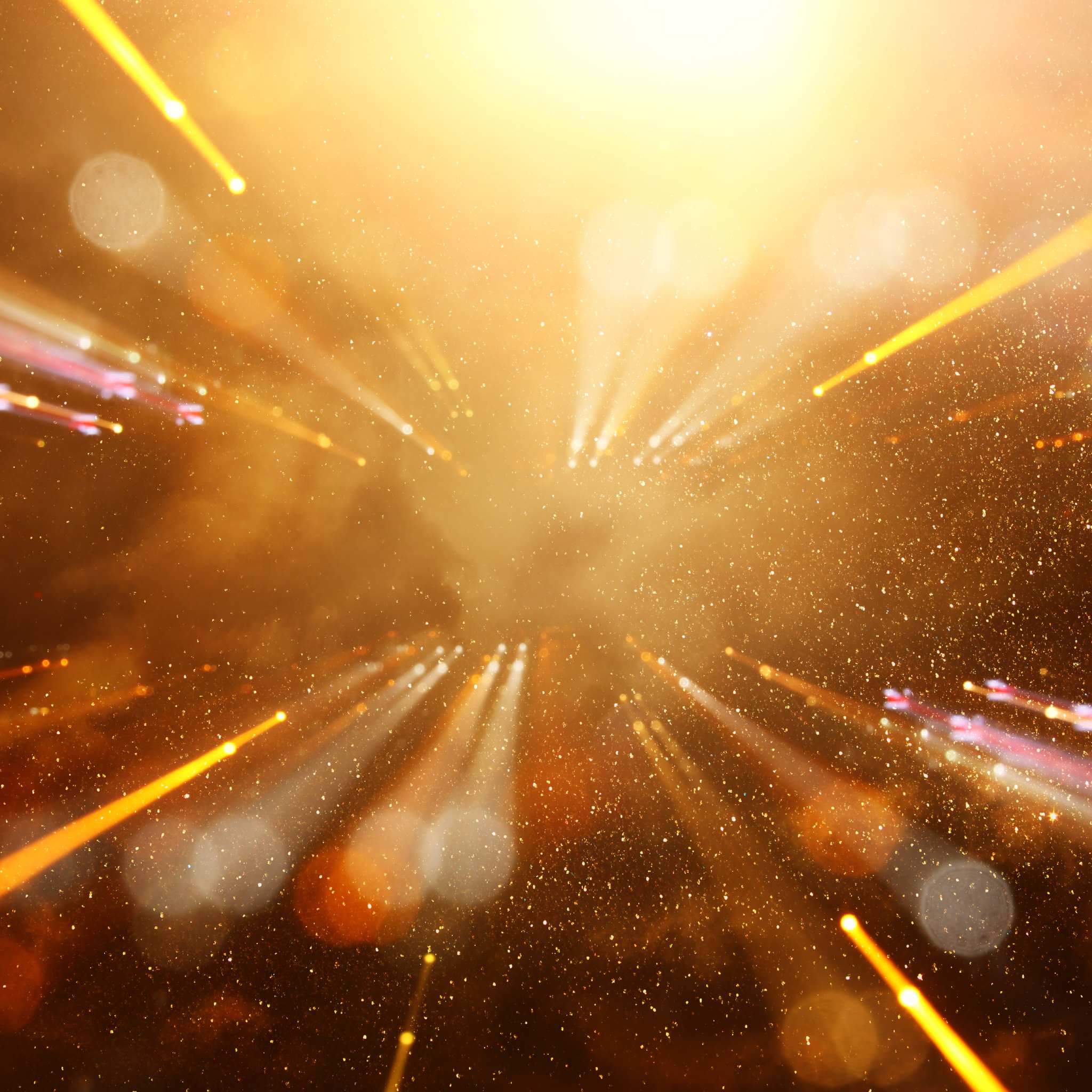 An abstract gold and brown background with bright, glowing light beams and bokeh particles radiating from the centre, representing Kuthumi connections.