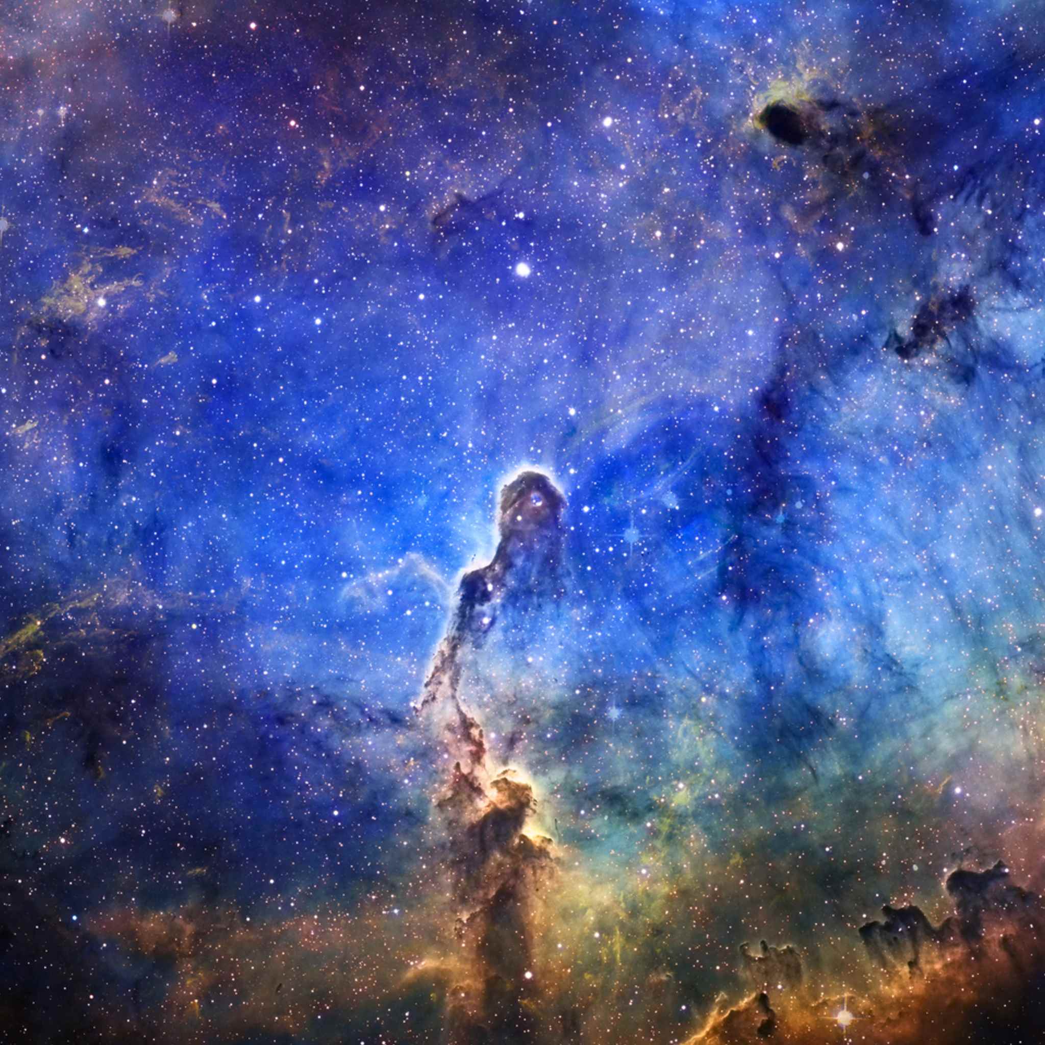 Colourful nebula with stars in space with a blue background.
