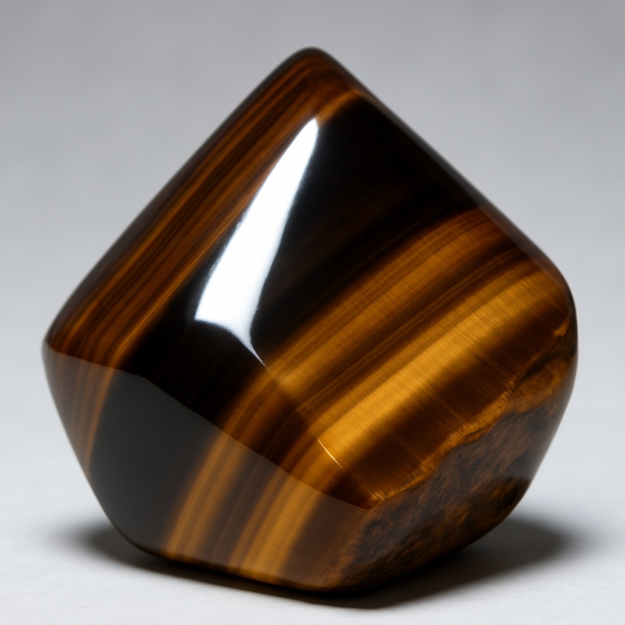 A polished, striped Tiger Eye gemstone, suggesting dynamic connections.
