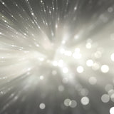 Radiant light effect with starburst and bokeh on a dark background.