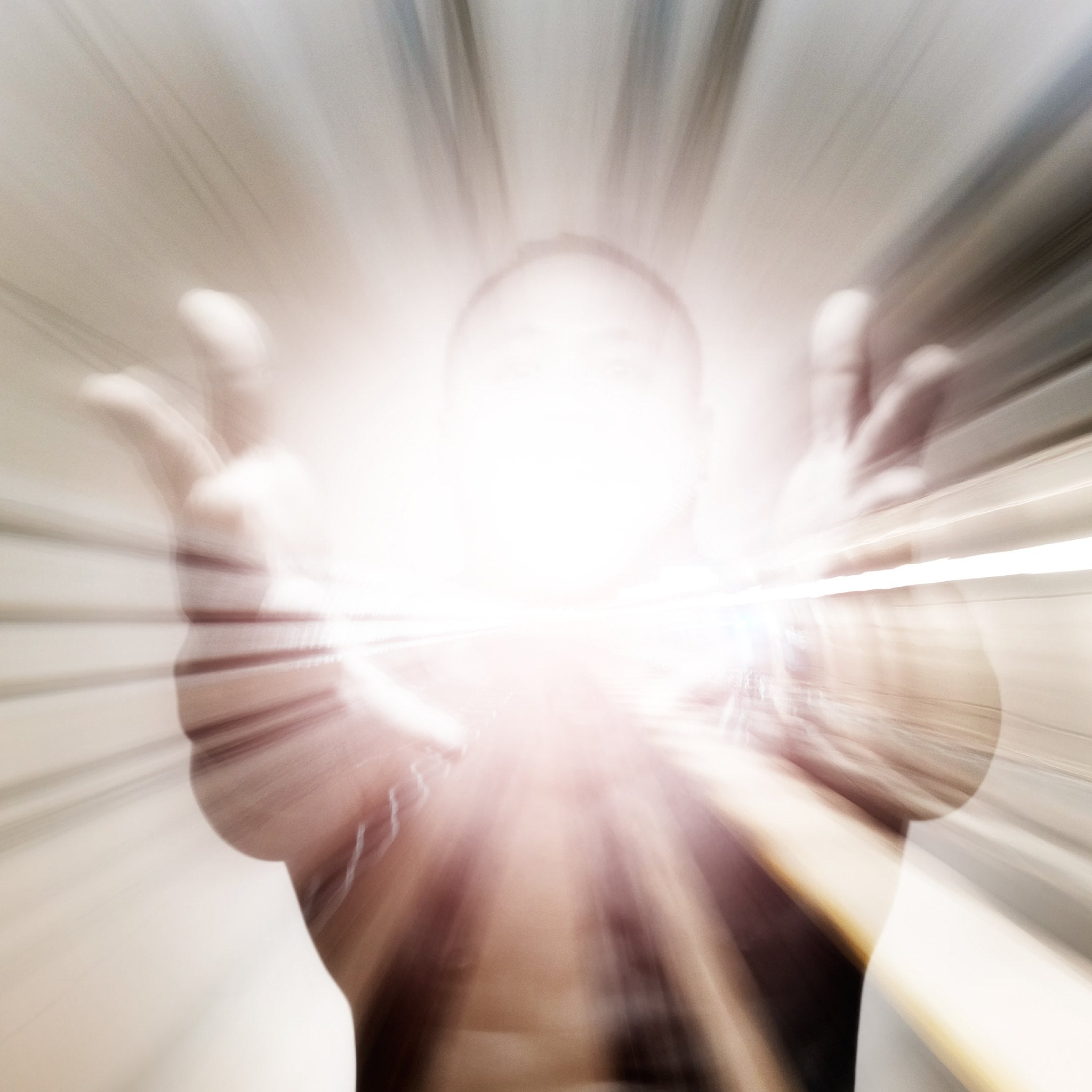 Abstract design with radial lines and a bright centre of light shining from a person.