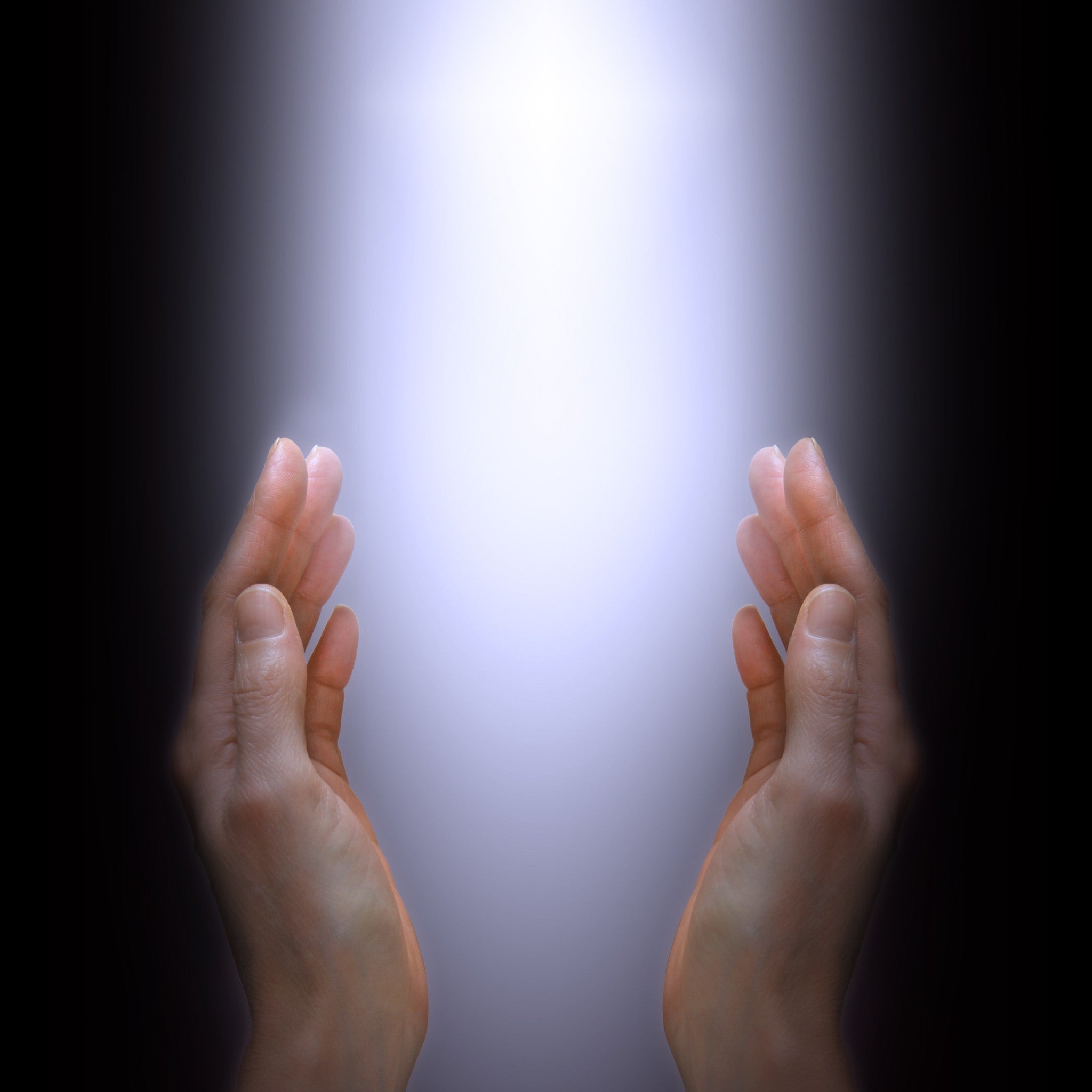 Two energy healer hands reaching towards a bright light source with a dark background.
