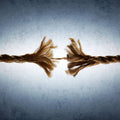Etheric Cord Cutting Treatment: two ends of a broken rope on a textured grey background symbolising non-serving etheric cord removal.