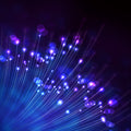 An abstract digital illustration featuring a radiant burst of converging blue and purple light beams and glowing bokeh circles rising from the bottom corner against a dark background. This representation of protective energy symbolises etheric cord safeguard.