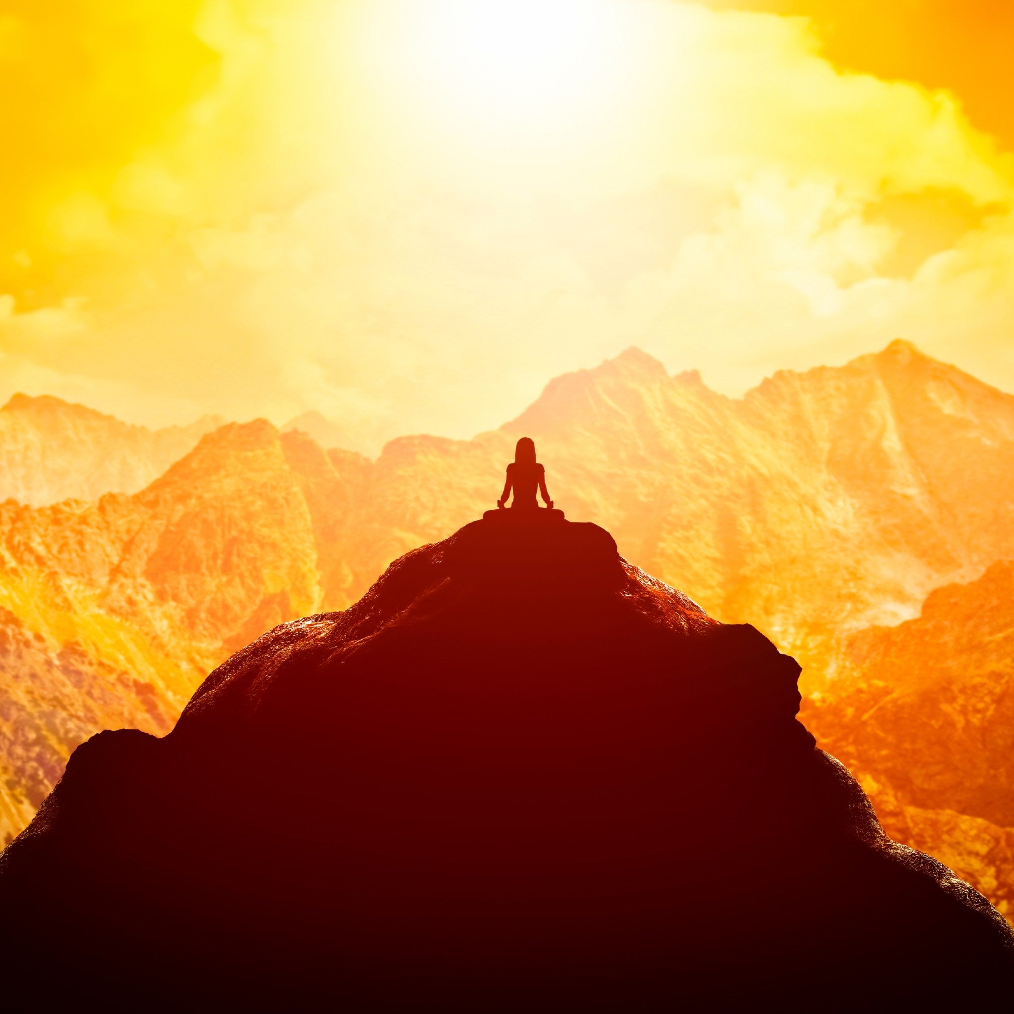 A small silhouette of a person sitting in a meditation pose atop a dark, jagged mountain peak, dramatically back-lit by a glowing, fiery orange and yellow sky with large, rugged mountains in the background.