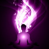 Silhouette of a person meditating with a swirling purple kundalini energy.
