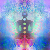A highly colourful, abstract digital illustration featuring a seated meditating silhouette, overlaid with the seven energy centres of the body, or chakras, represented by glowing, coloured symbols. The background is a vibrant, swirling mix of blue, pink, and purple light, symbolising the intense energy of the kundalini awakening.