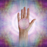 Spiral pattern in the palm of the Reiki master's hand on a multicoloured, abstract background.