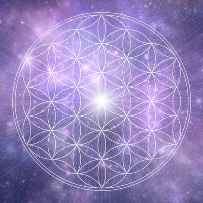 A luminous white outline of the Flower of Life sacred geometry symbol, centred with a bright starburst, set against a vibrant, swirling purple and pink cosmic background with stars, representing universal harmony and spiritual connection.