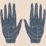A symmetrical illustration featuring two hands raised with palms facing out, set against a pale pink background. The hands are solid navy blue, intricately decorated with fine white line art showing floral, leaf, and geometric patterns, including an eye symbol at the base of the palm, representing ancestral third eye enhancement.