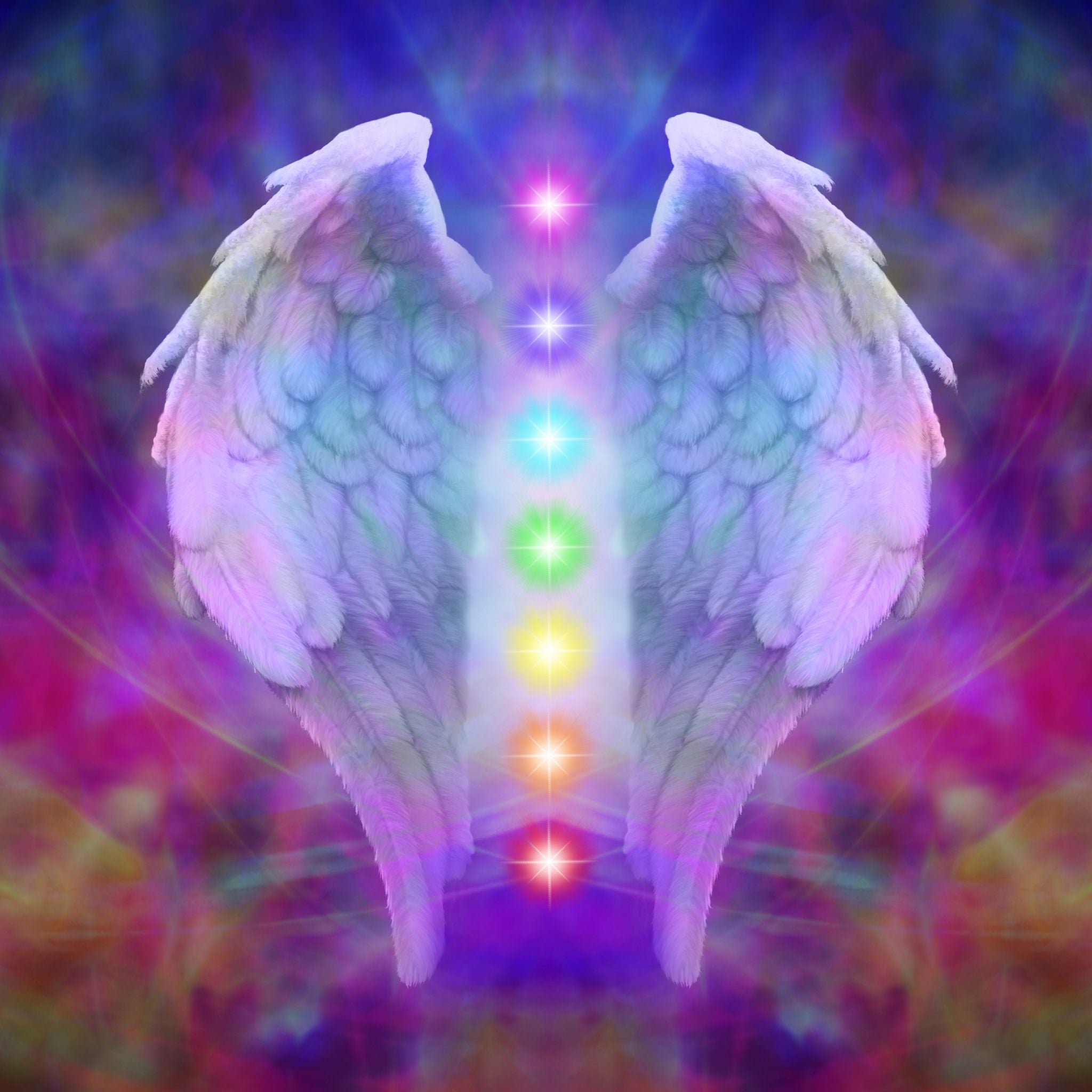 Pair of angelic wings with a column of rainbow chakra lights, representing angelic chakra realignment treatment.