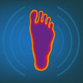 Colourful thermographic representation of a foot on a blue background.