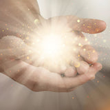 Close-up of a hand with glowing Hand Chakras with a soft focus background.