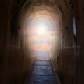 Ultimate Life Path Magic Clearing Treatment: dark stone tunnel leading to a bright light and clouds, symbolising future direction and clarity.