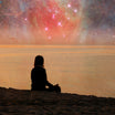 A silhouette of a person in meditation on a beach, with a celestial nebula and stars in the sky, symbolising spiritual connection and cosmic alignment.