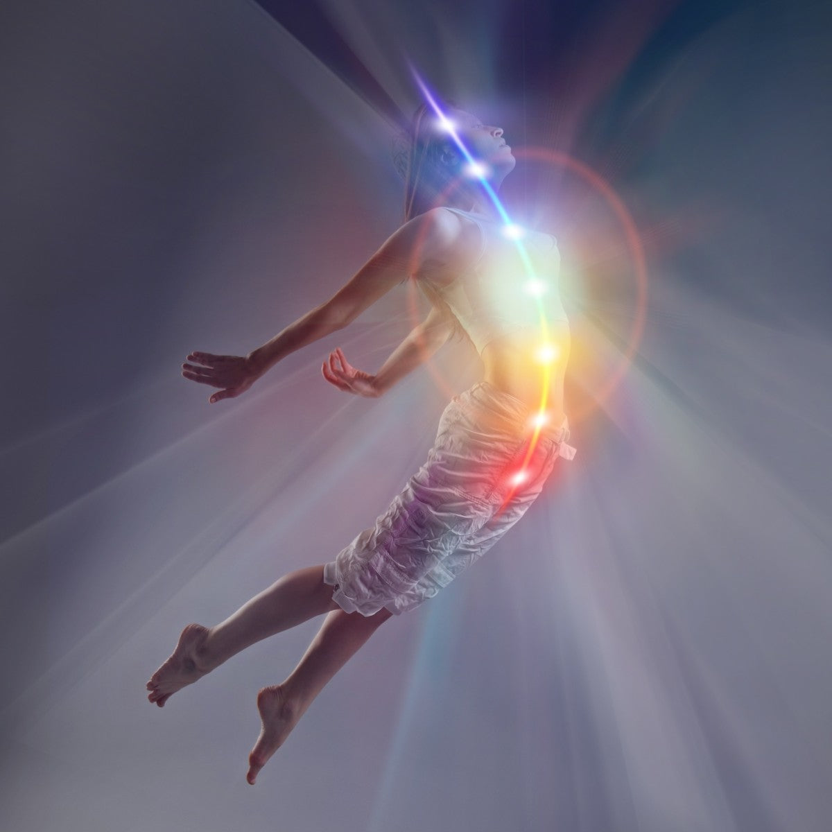 Person floating with glowing kundalini light against a dark background.