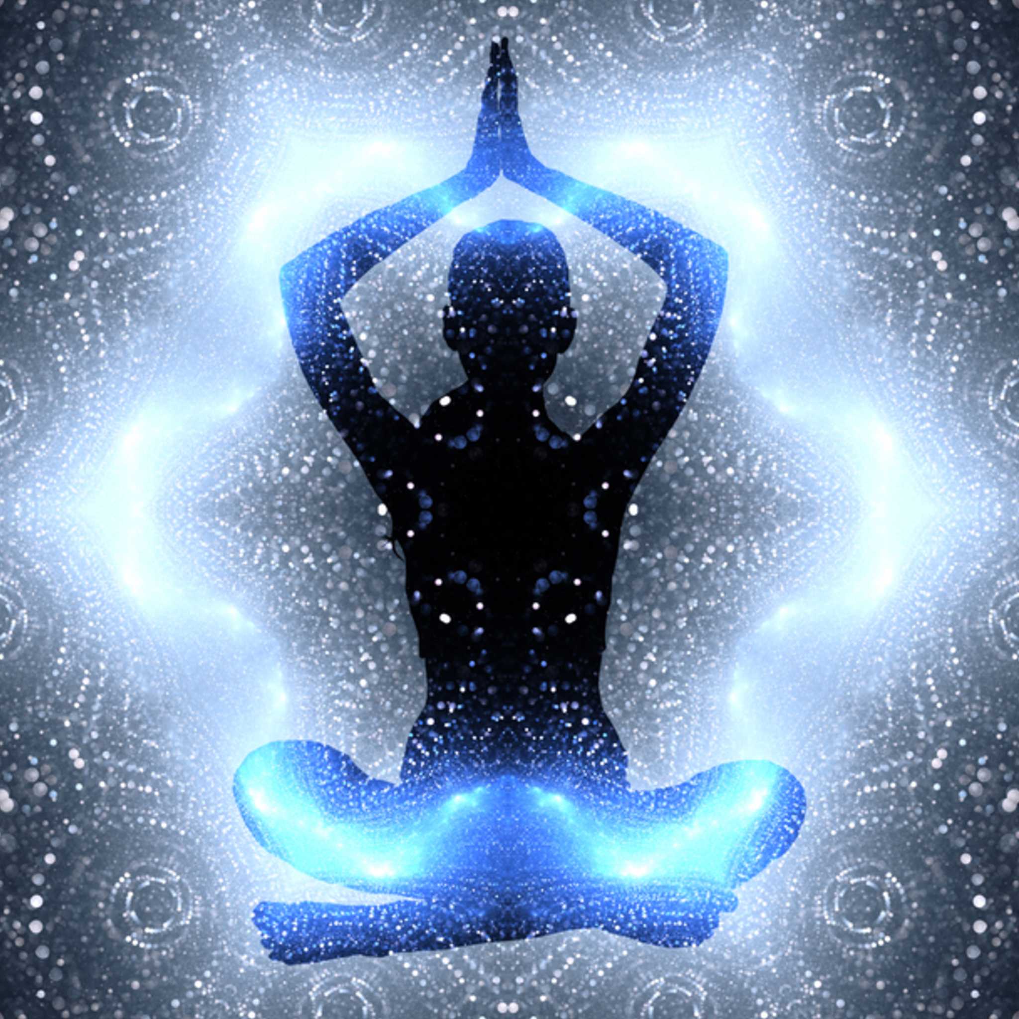 A silhouette of a meditating person sitting in a lotus position, with glowing blue and white light radiating from their body, surrounded by an intricate, sparkling mandala pattern.