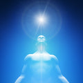Blue-tinged figure with a bright light source above, against a blue background