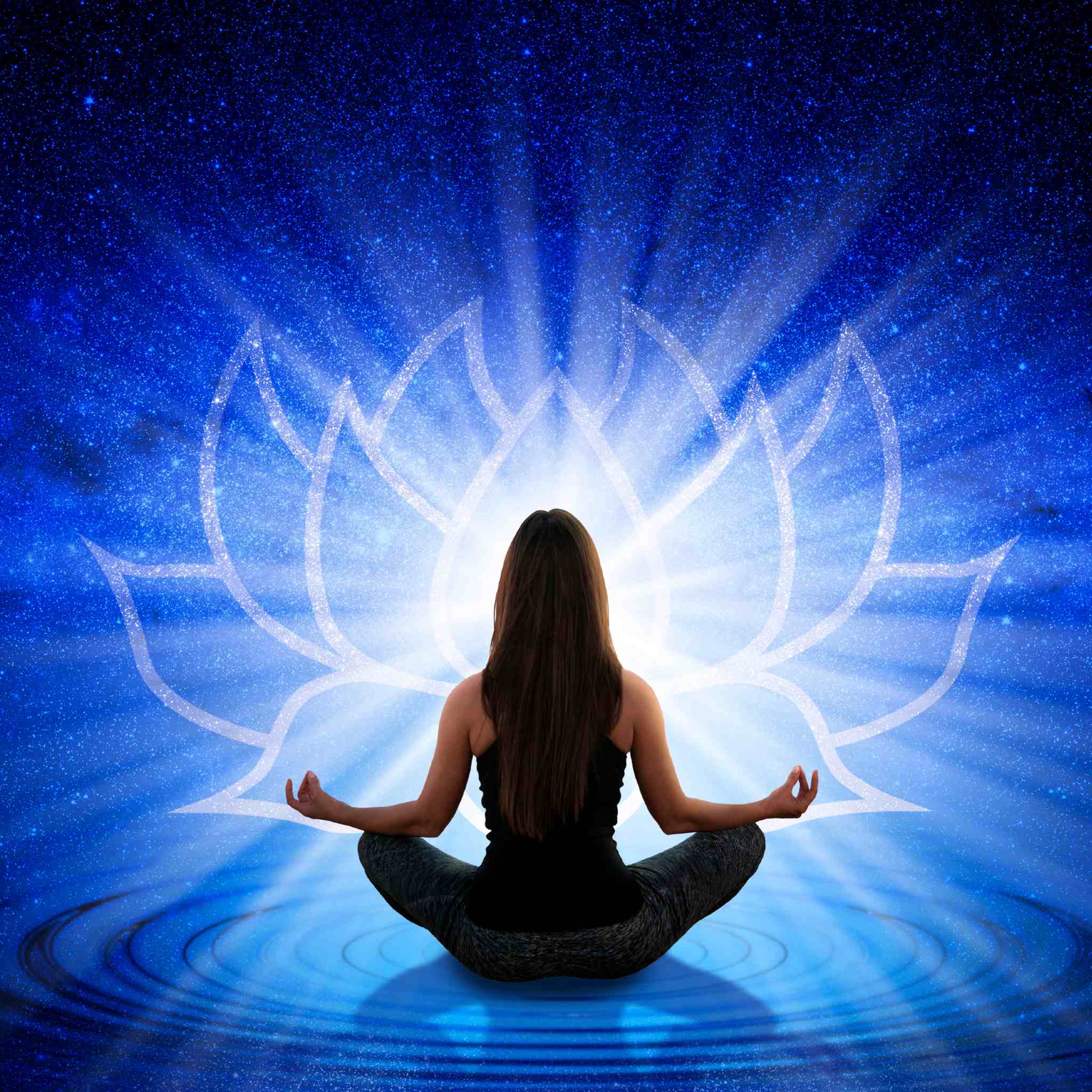 A woman sits in a meditation pose (lotus position) with her back to the viewer, against a vivid, deep blue background depicting a starry sky and a pool of water with ripples. A large, bright white outline of a lotus flower radiates light behind her head, symbolising third eye ascension and spiritual enhancement.